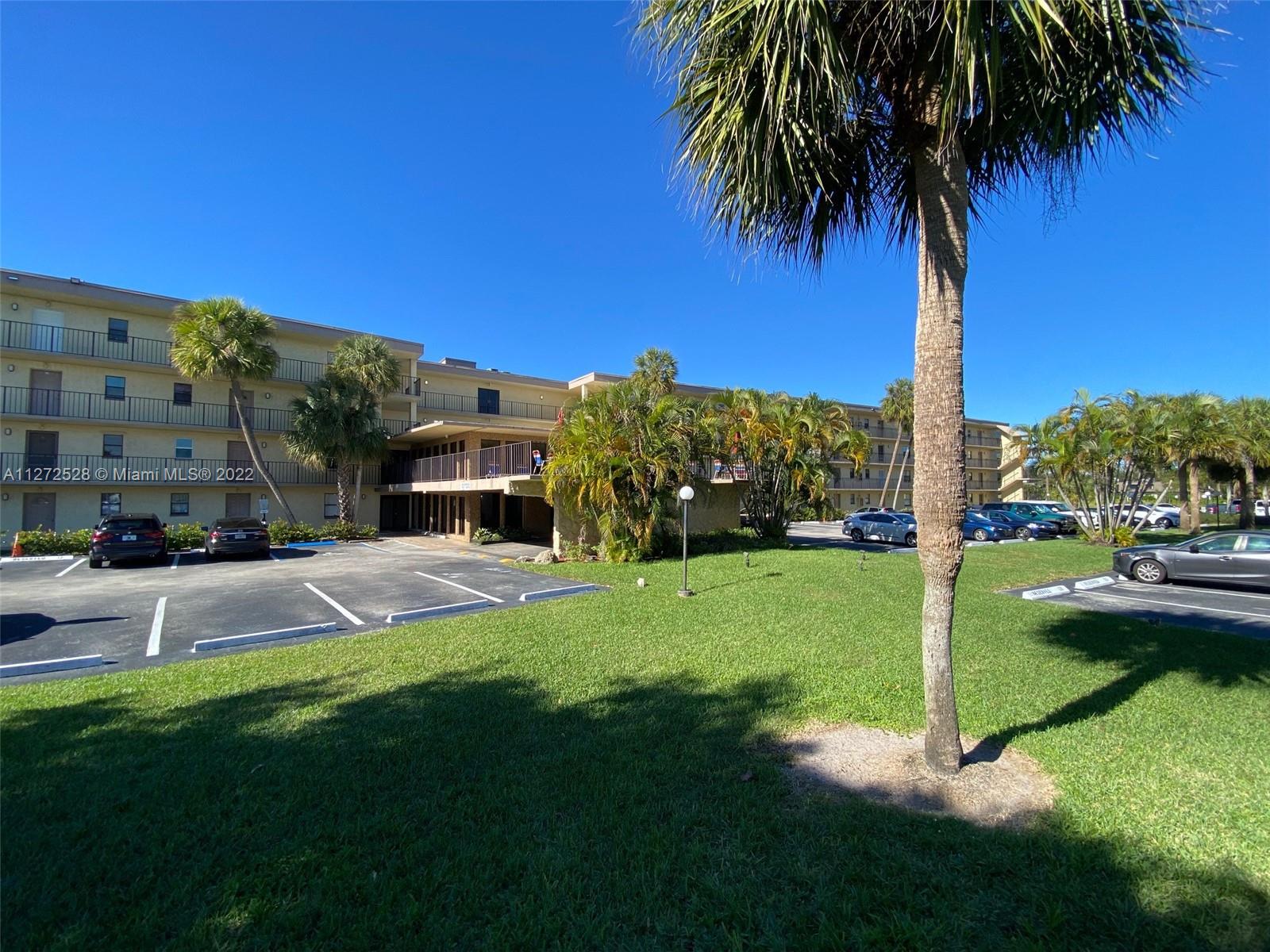 9355 Southwest 8th Street, Unit 216 Boca Raton, FL 33428 - Photo 14 of 15 a view of a house with a poll and yard
