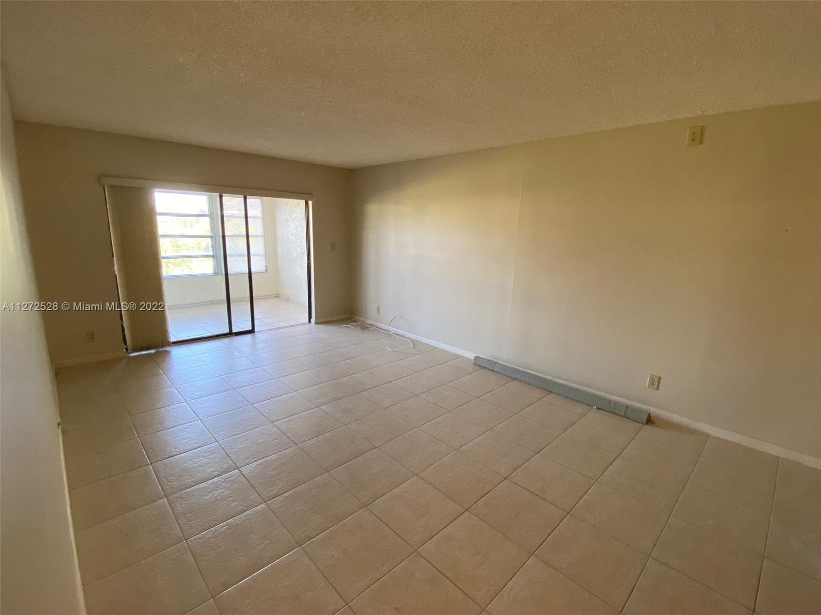 9355 Southwest 8th Street, Unit 216 Boca Raton, FL 33428 - Photo 6 of 15 an empty room with windows