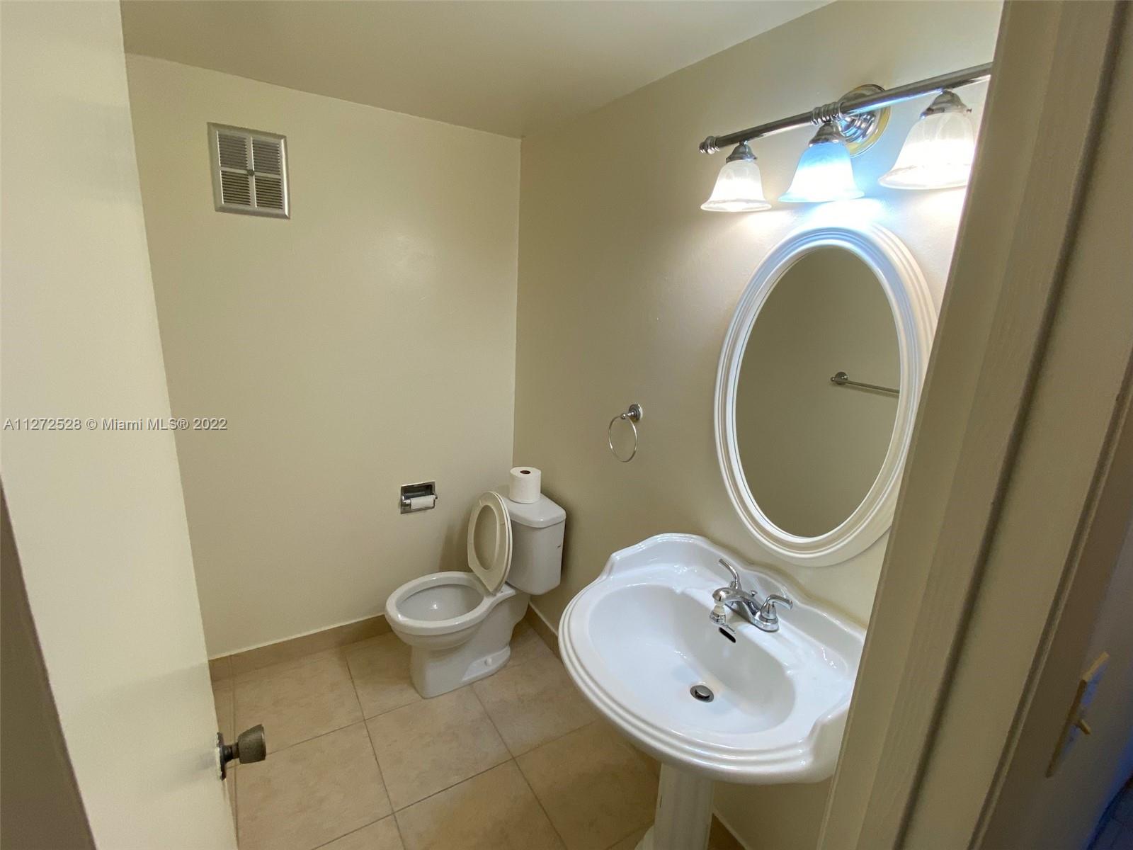9355 Southwest 8th Street, Unit 216 Boca Raton, FL 33428 - Photo 8 of 15 a bathroom with a sink and a mirror