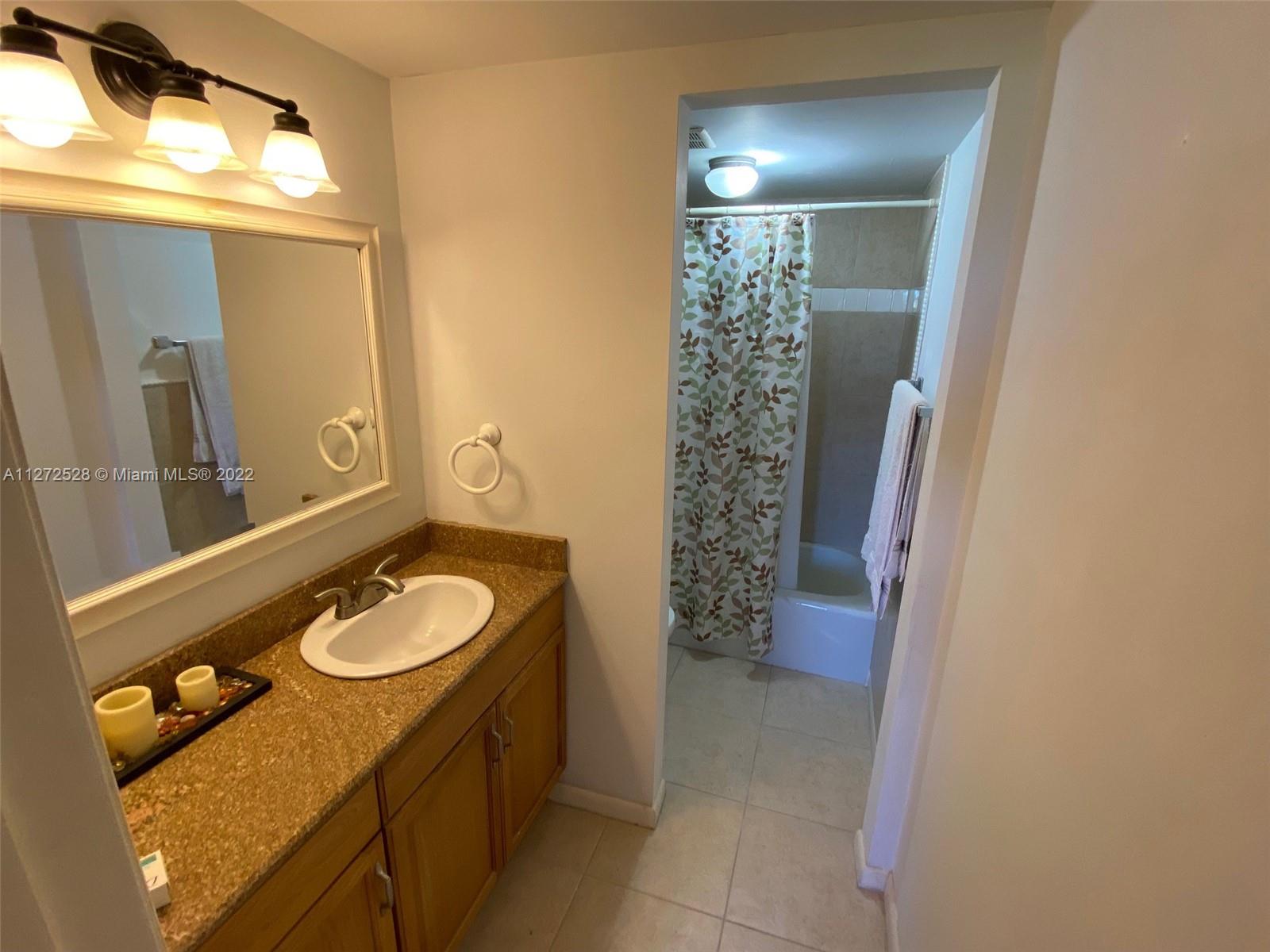 9355 Southwest 8th Street, Unit 216 Boca Raton, FL 33428 - Photo 9 of 15 a bathroom with a sink a toilet and shower