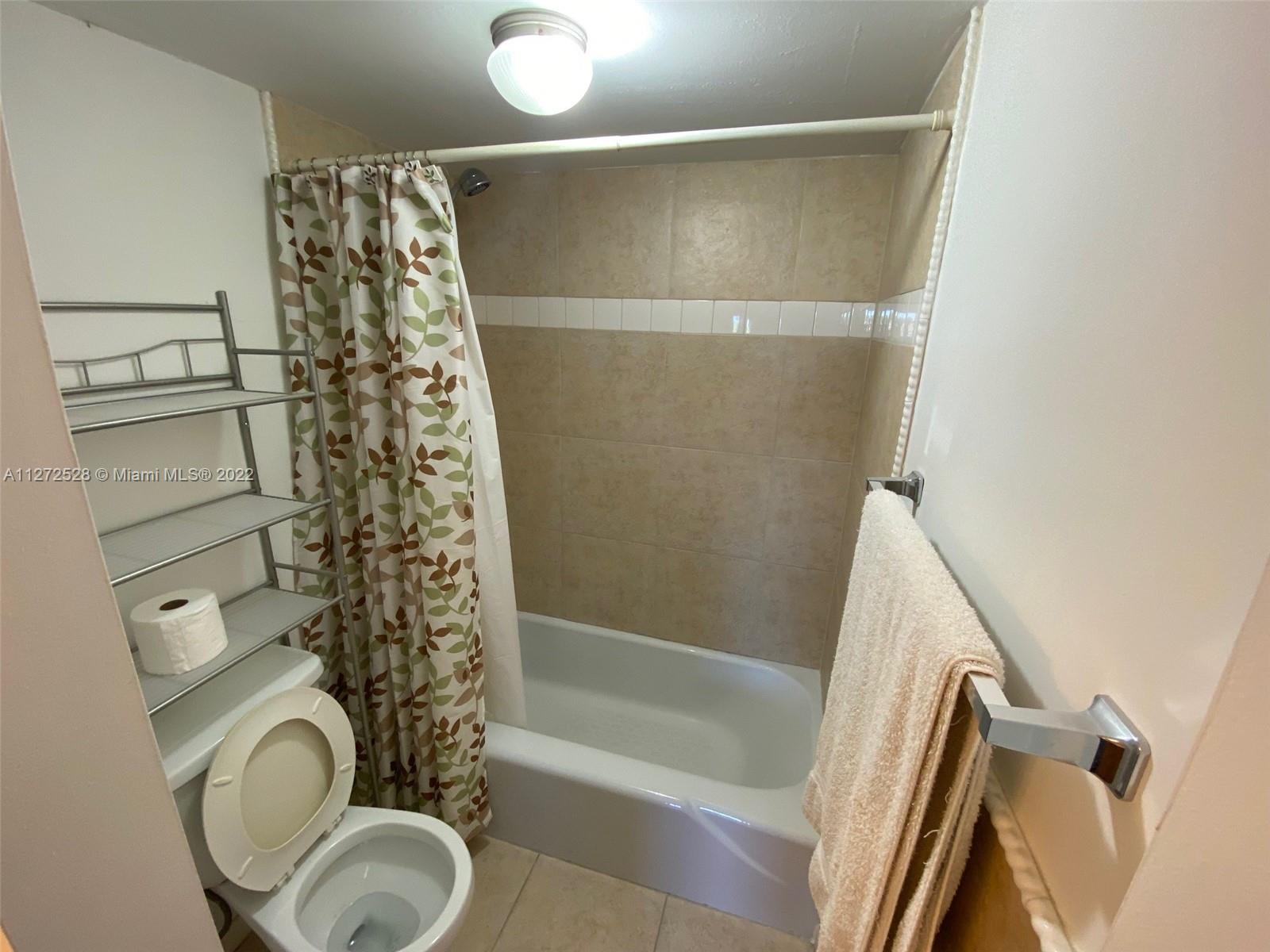 9355 Southwest 8th Street, Unit 216 Boca Raton, FL 33428 - Photo 10 of 15 a bathroom with a shower a toilet and a sink