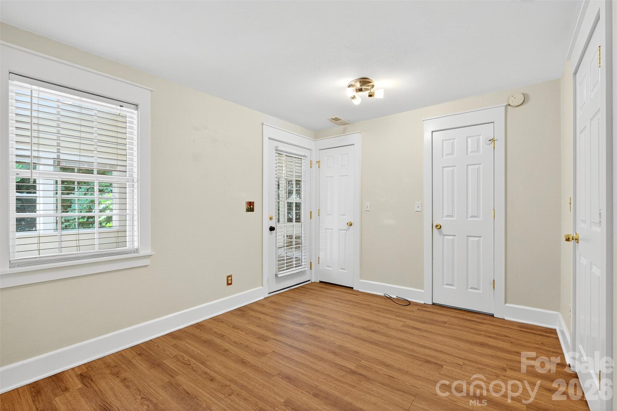 160 East Howard Street Tryon, NC 28782 - Photo 33 of 48 a view of an empty room with wooden floor and a window