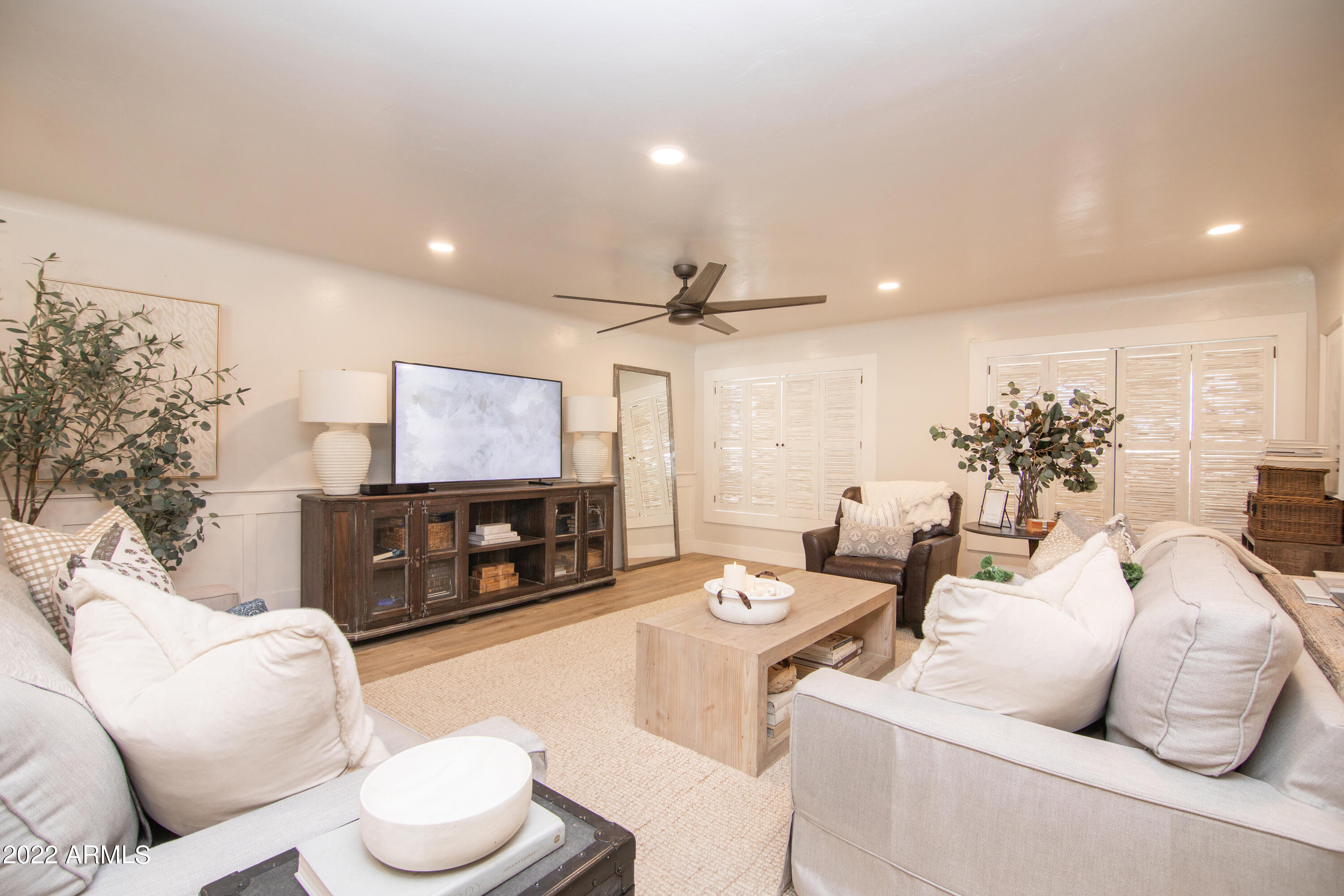 11044 North 36th Street Phoenix, AZ 85028 - Photo 11 of 49 a living room with furniture a large window and a flat screen tv