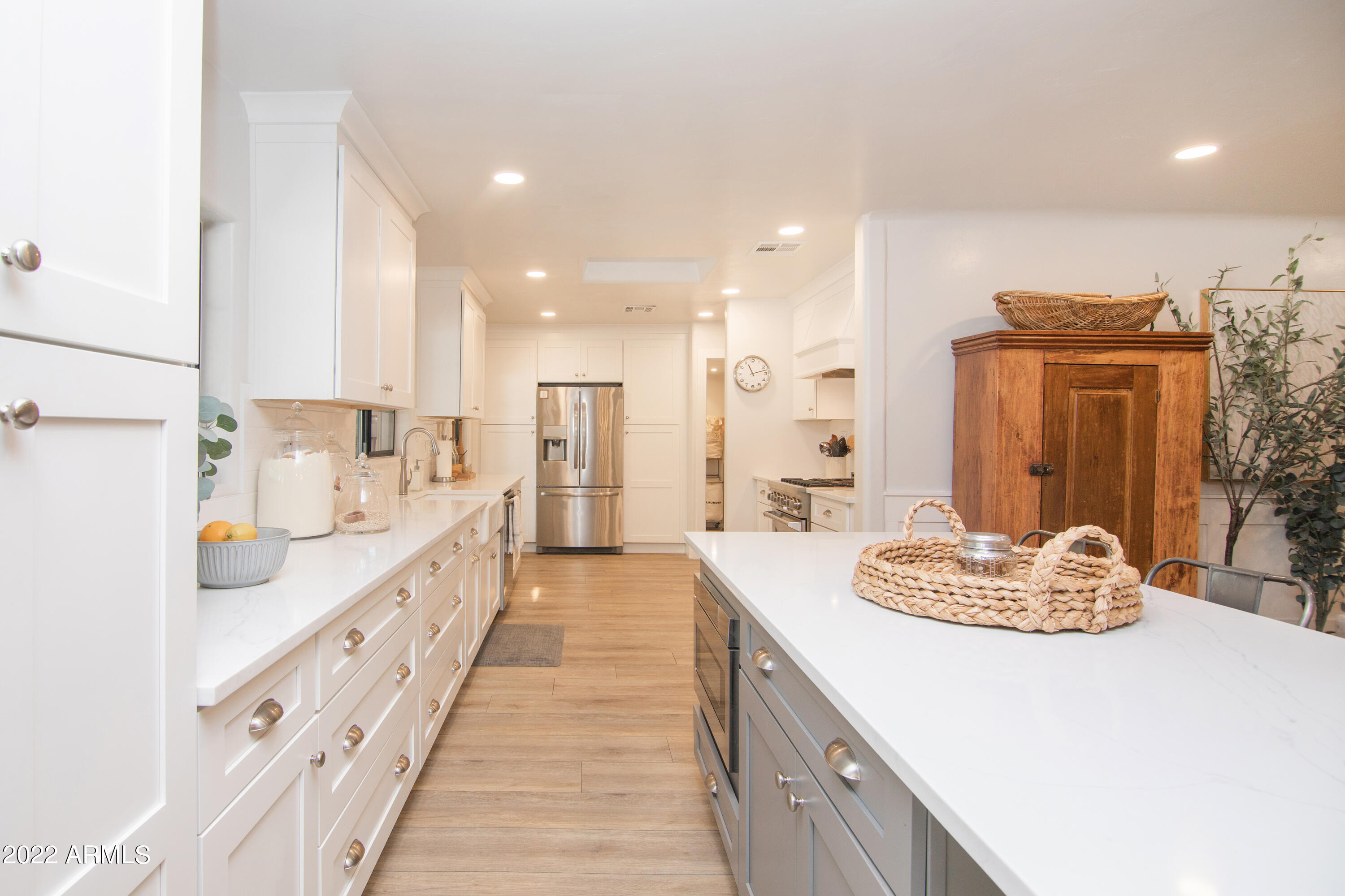 11044 North 36th Street Phoenix, AZ 85028 - Photo 14 of 49 a large white kitchen with a sink and dish washer