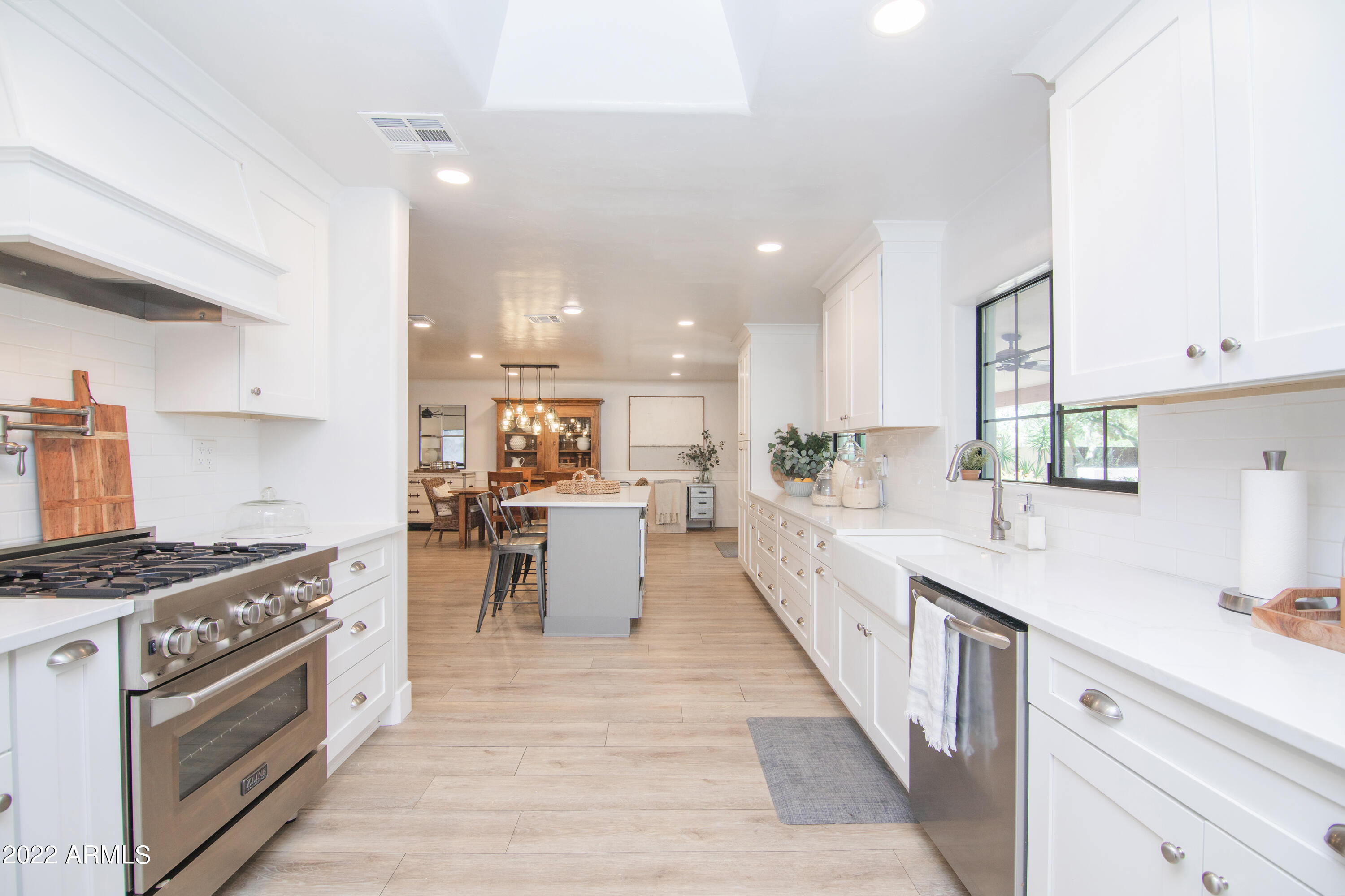 11044 North 36th Street Phoenix, AZ 85028 - Photo 17 of 49 a large white kitchen with stainless steel appliances