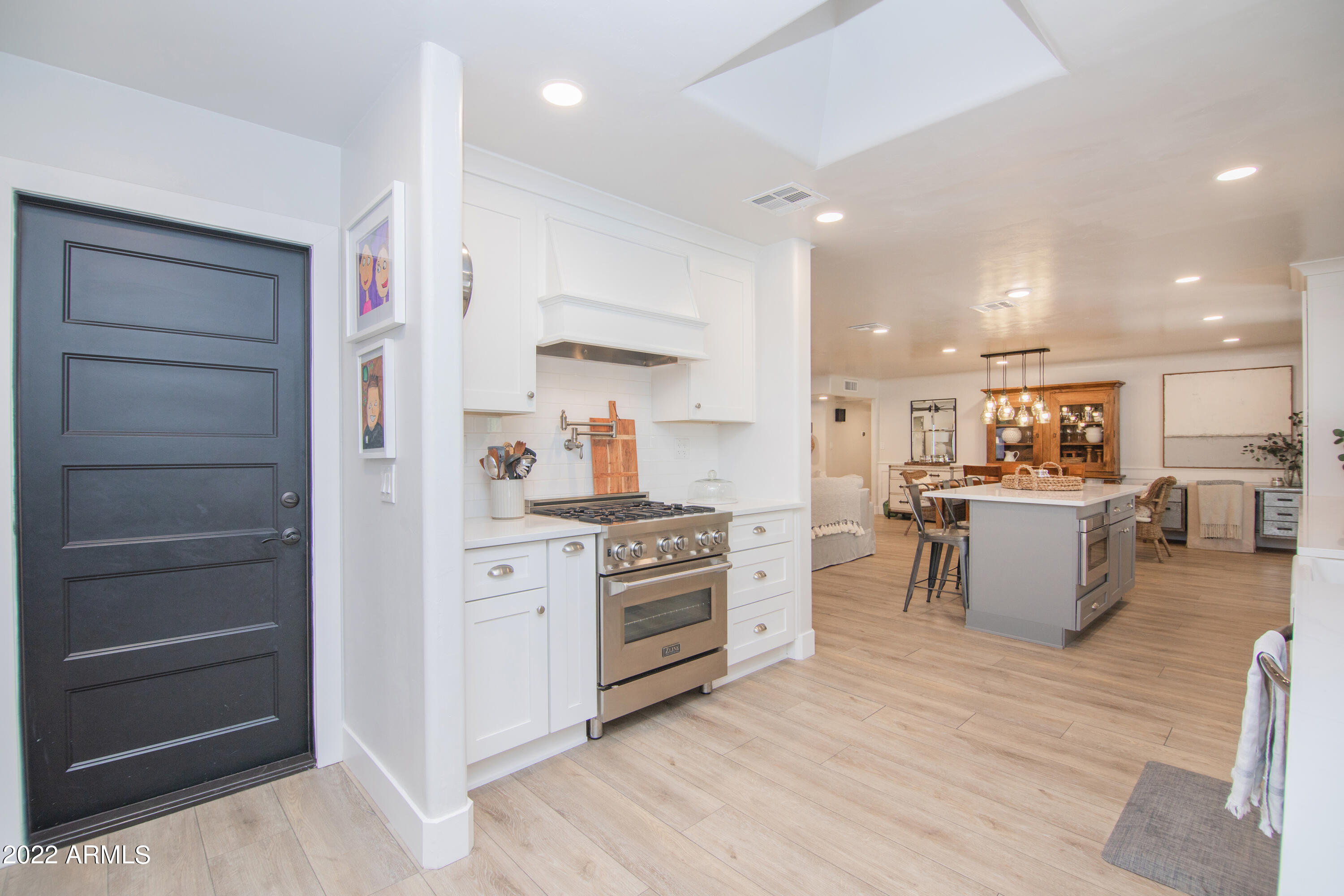 11044 North 36th Street Phoenix, AZ 85028 - Photo 18 of 49 a kitchen with stainless steel appliances a stove top oven and sink