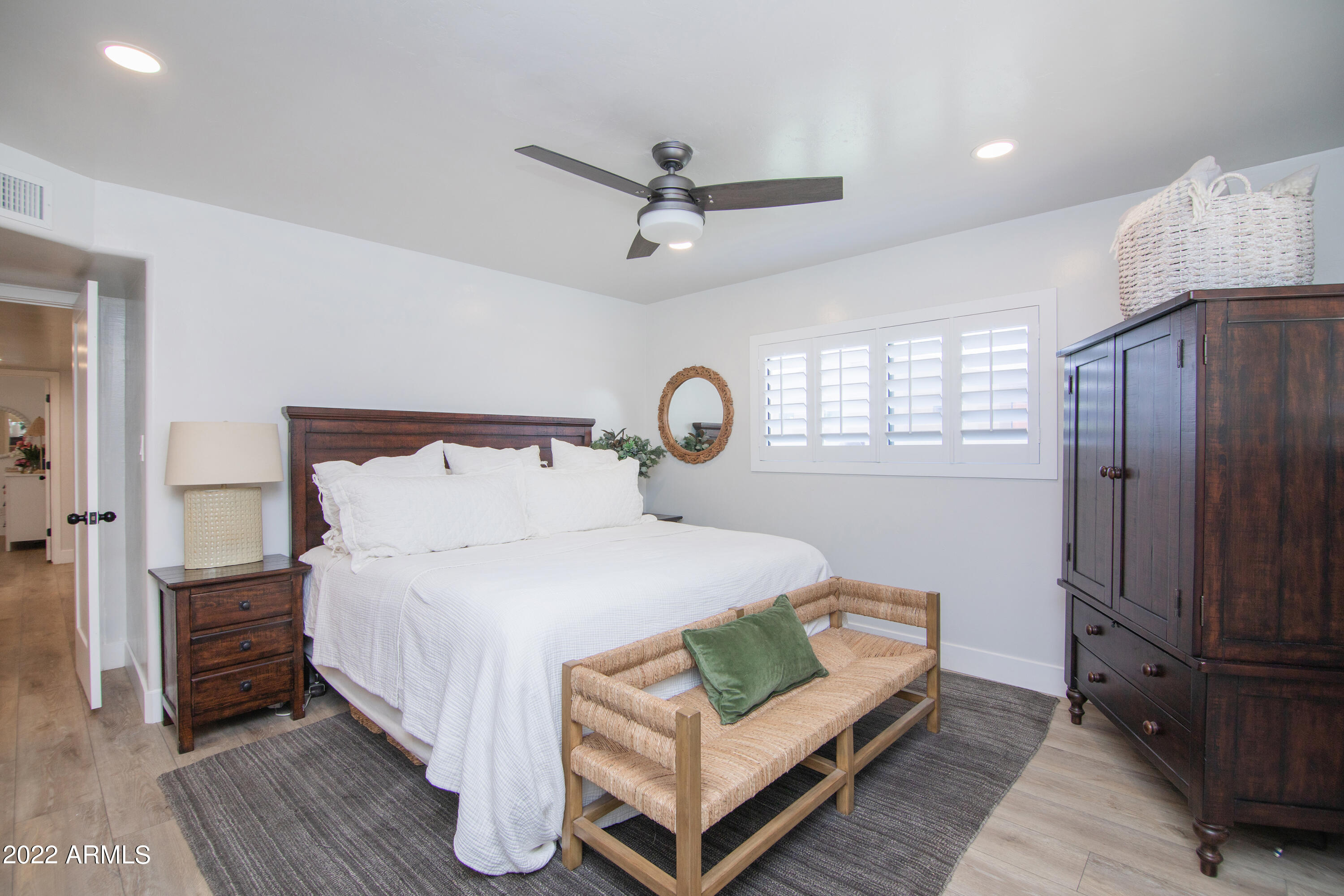 11044 North 36th Street Phoenix, AZ 85028 - Photo 22 of 49 a bedroom with a bed wooden floor and window