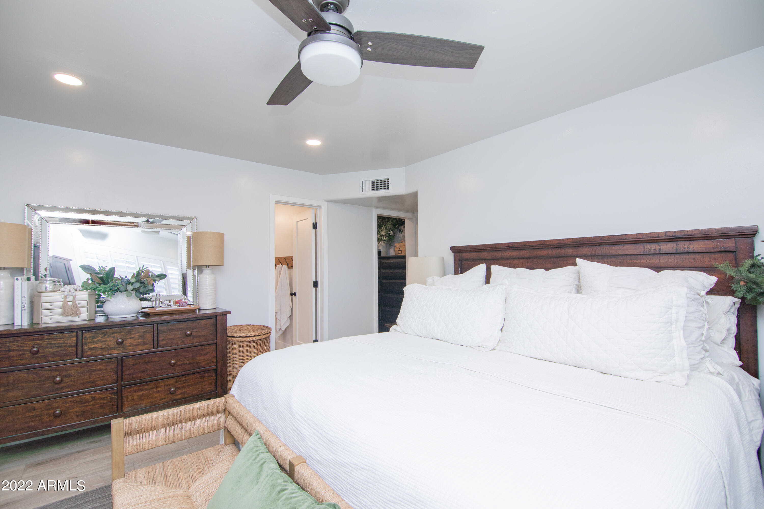 11044 North 36th Street Phoenix, AZ 85028 - Photo 24 of 49 a bedroom with a large bed and a dresser