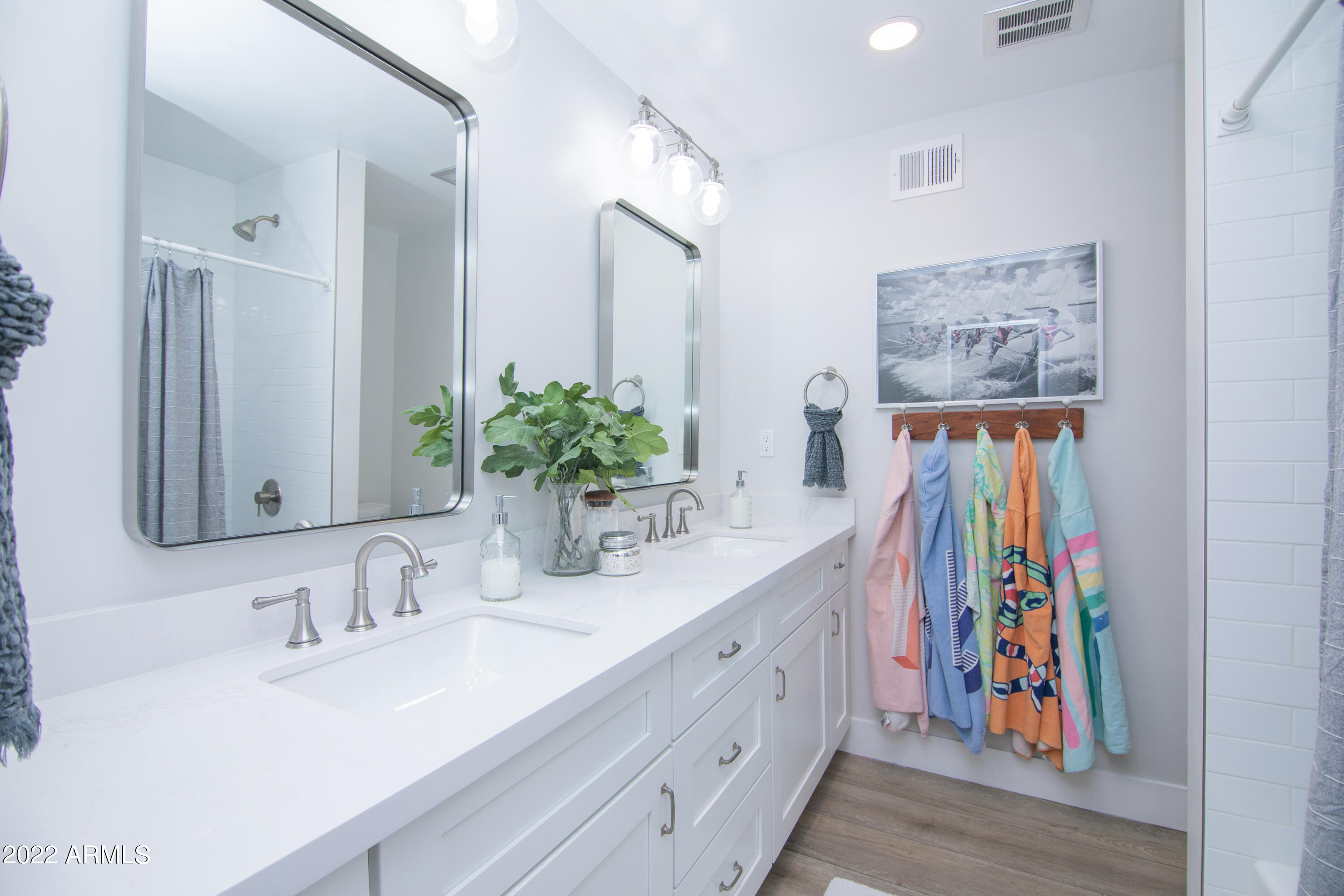 11044 North 36th Street Phoenix, AZ 85028 - Photo 28 of 49 a bathroom with a sink a mirror and a shower