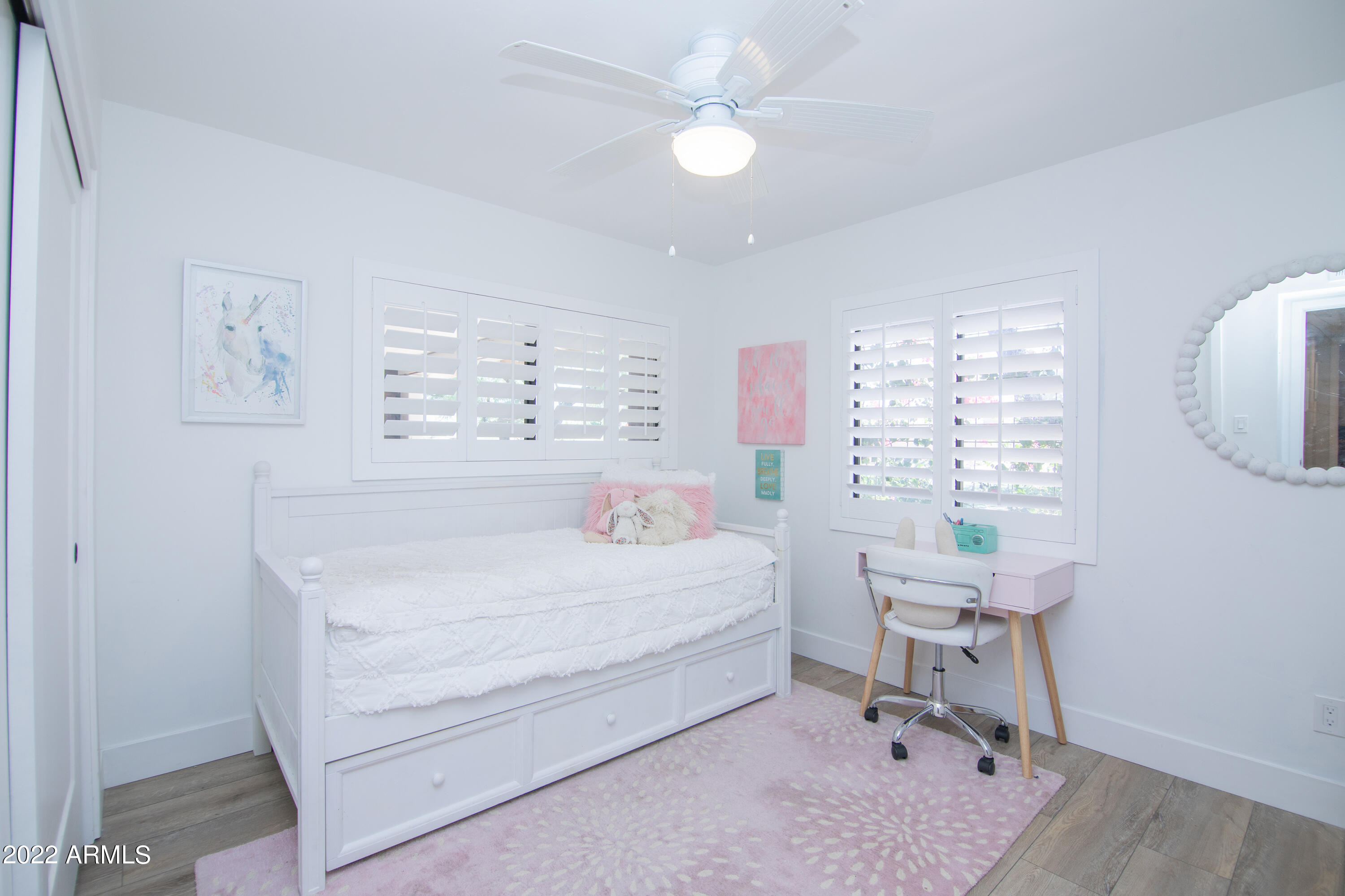 11044 North 36th Street Phoenix, AZ 85028 - Photo 32 of 49 a bedroom with a bed a chandelier and a window
