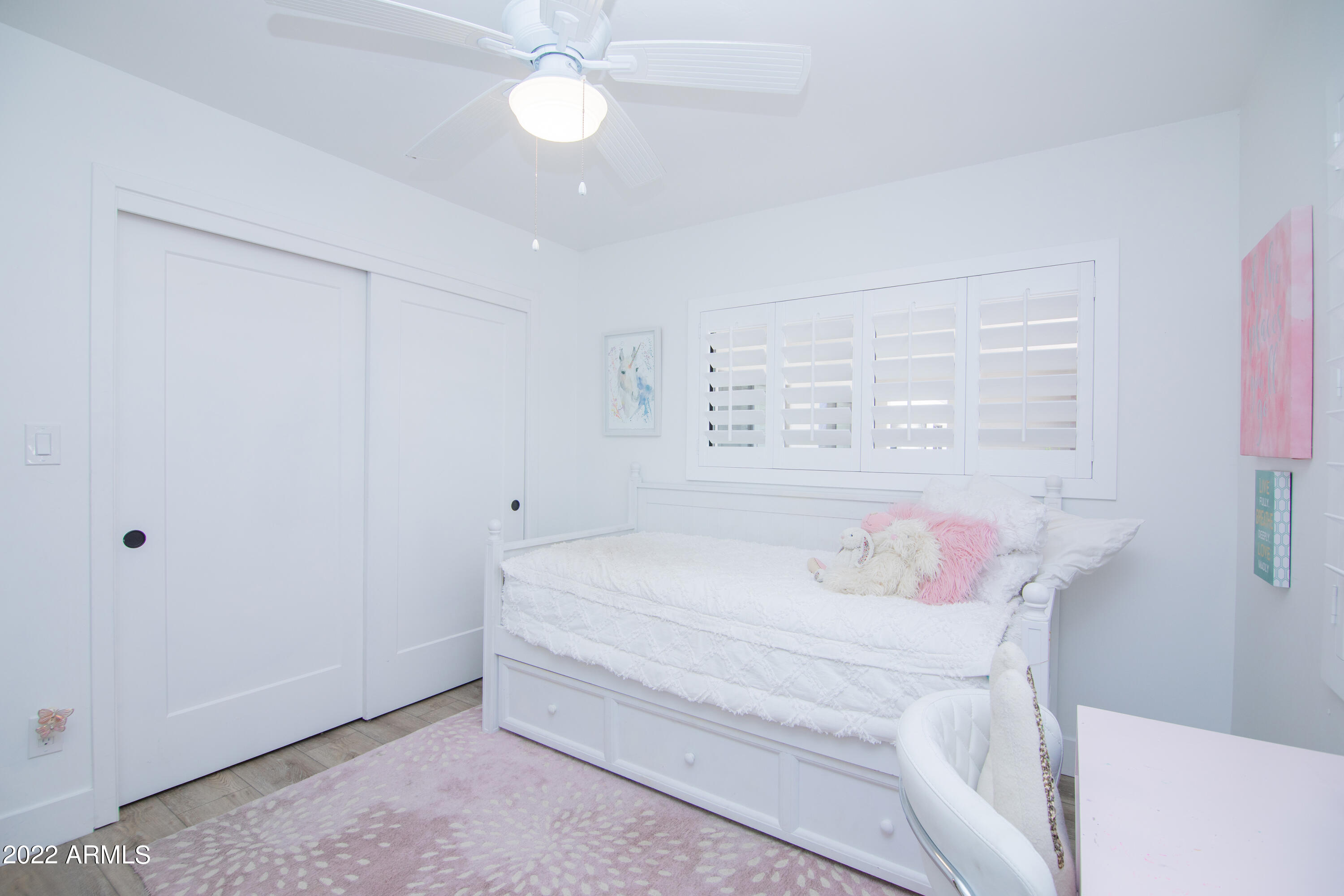 11044 North 36th Street Phoenix, AZ 85028 - Photo 33 of 49 a bedroom with a bed and a chandelier