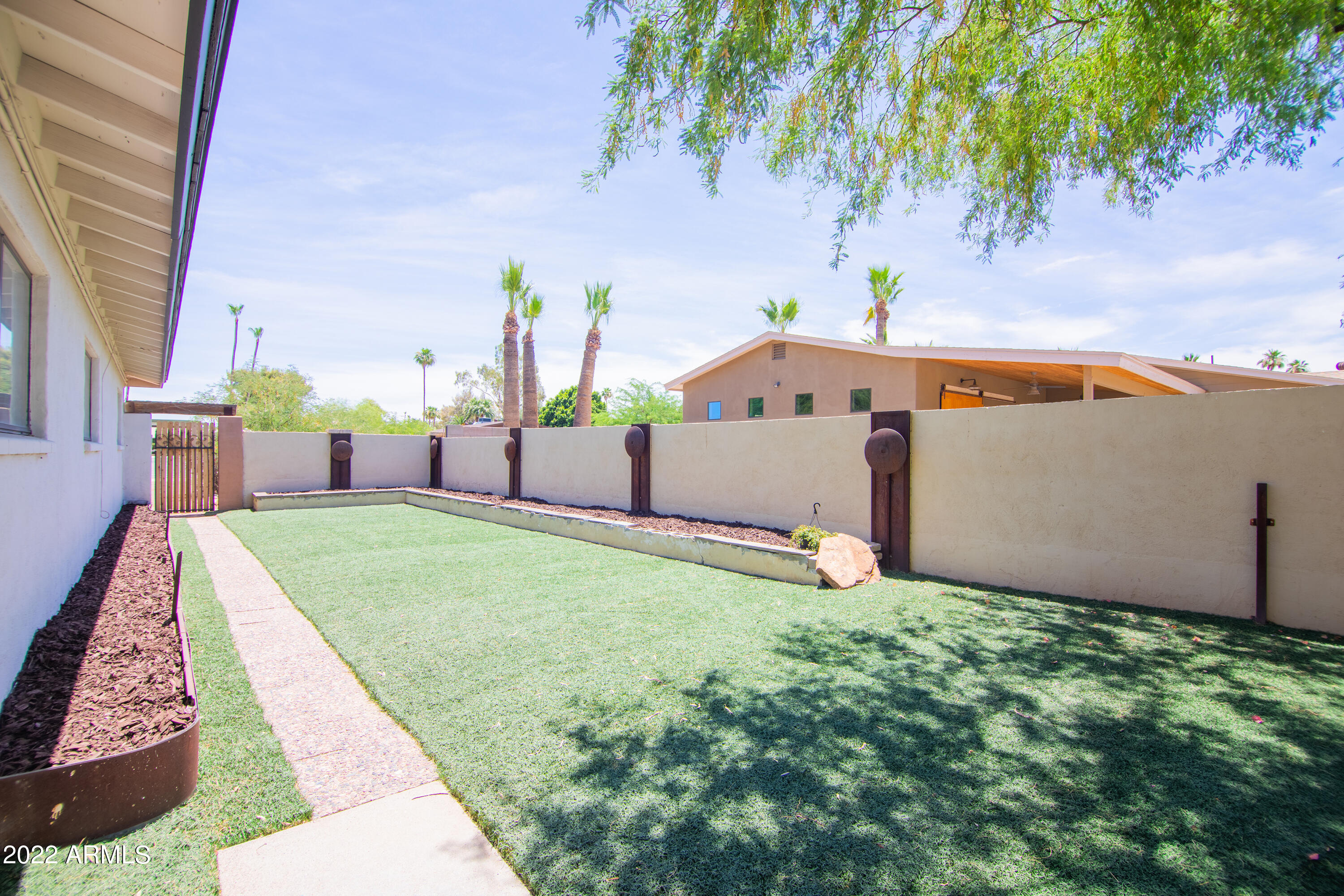 11044 North 36th Street Phoenix, AZ 85028 - Photo 45 of 49 a backyard of a house with table and chairs