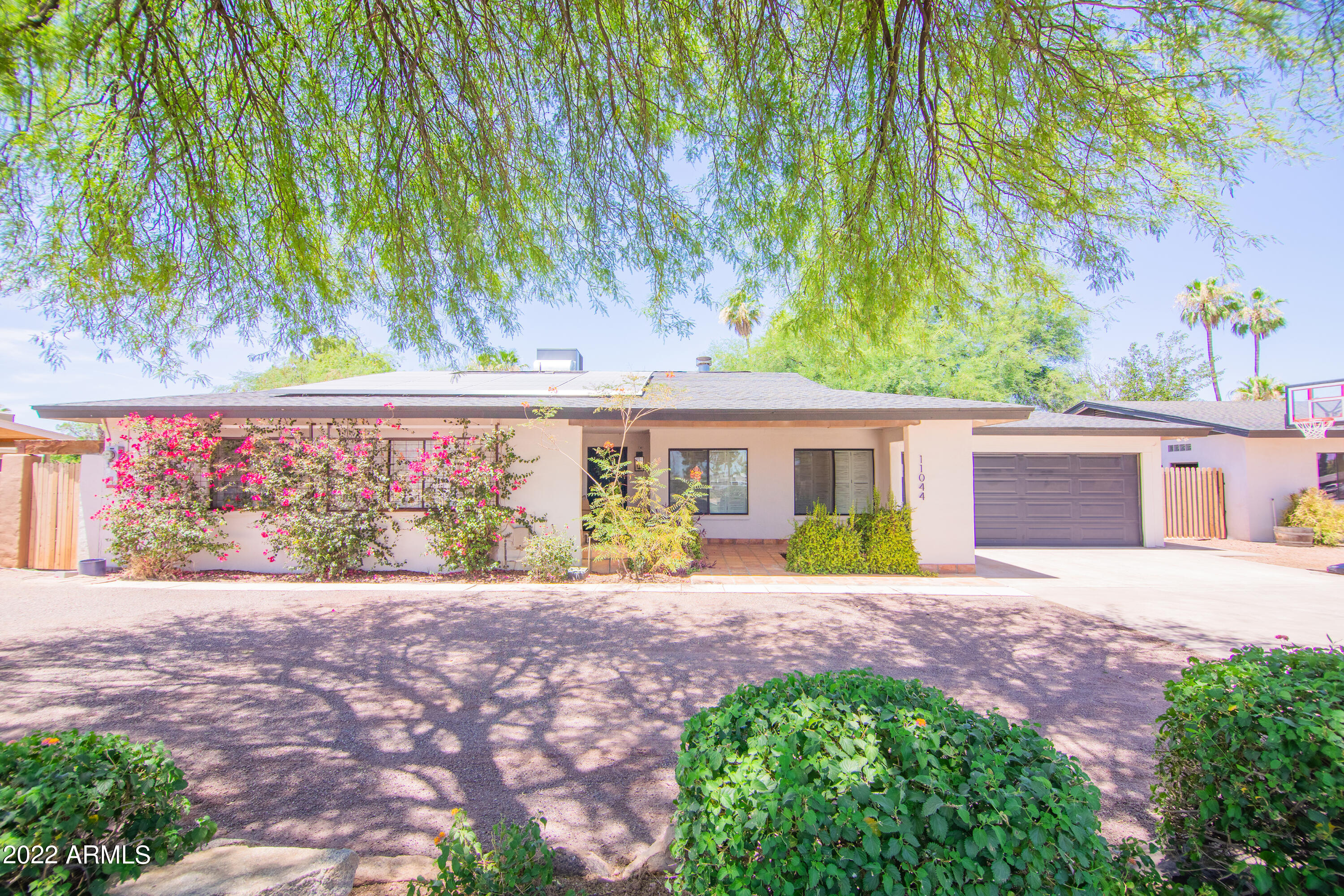 11044 North 36th Street Phoenix, AZ 85028 - Photo 6 of 49 a front view of a house with a garden and patio