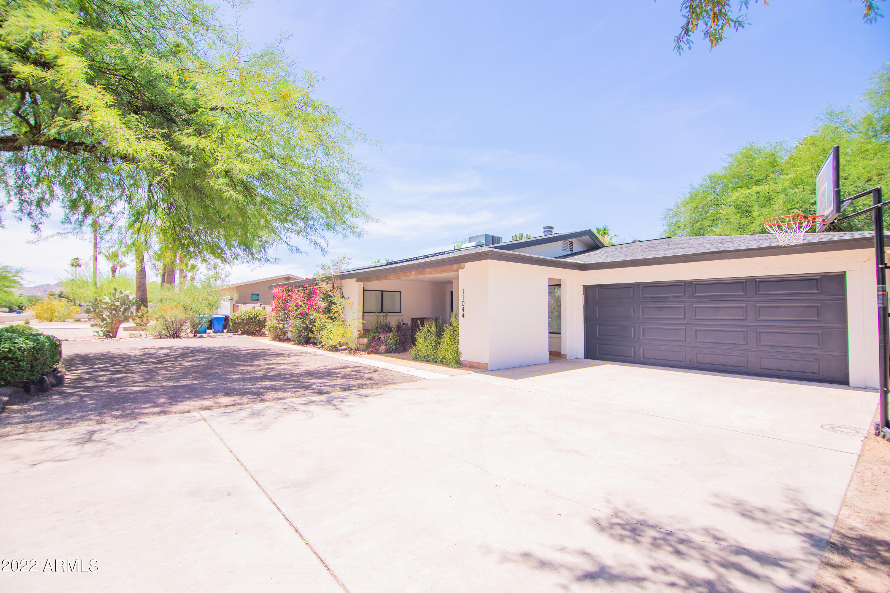 11044 North 36th Street Phoenix, AZ 85028 - Photo 7 of 49 a front view of a house with a yard and garage
