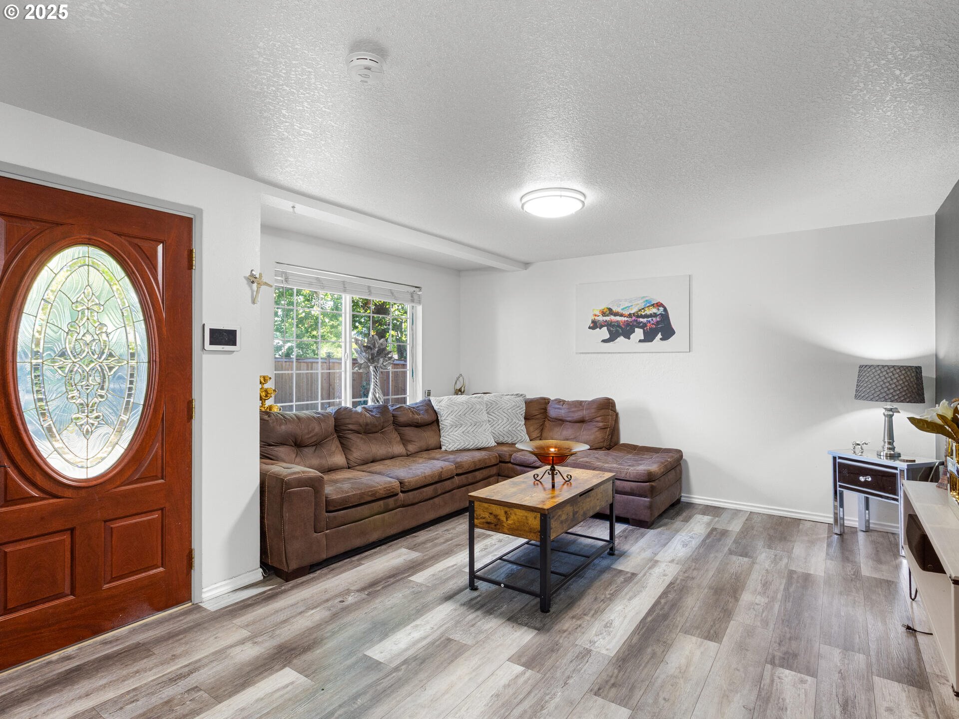 8292 Northeast Snowberry Loop Vancouver, WA 98664 - Photo 11 of 48 a living room with furniture a rug a window and a potted plant