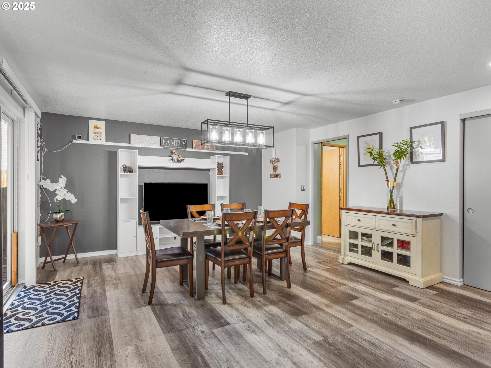 8292 Northeast Snowberry Loop Vancouver, WA 98664 - Photo 15 of 48 a view of a dining room with furniture and chandelier