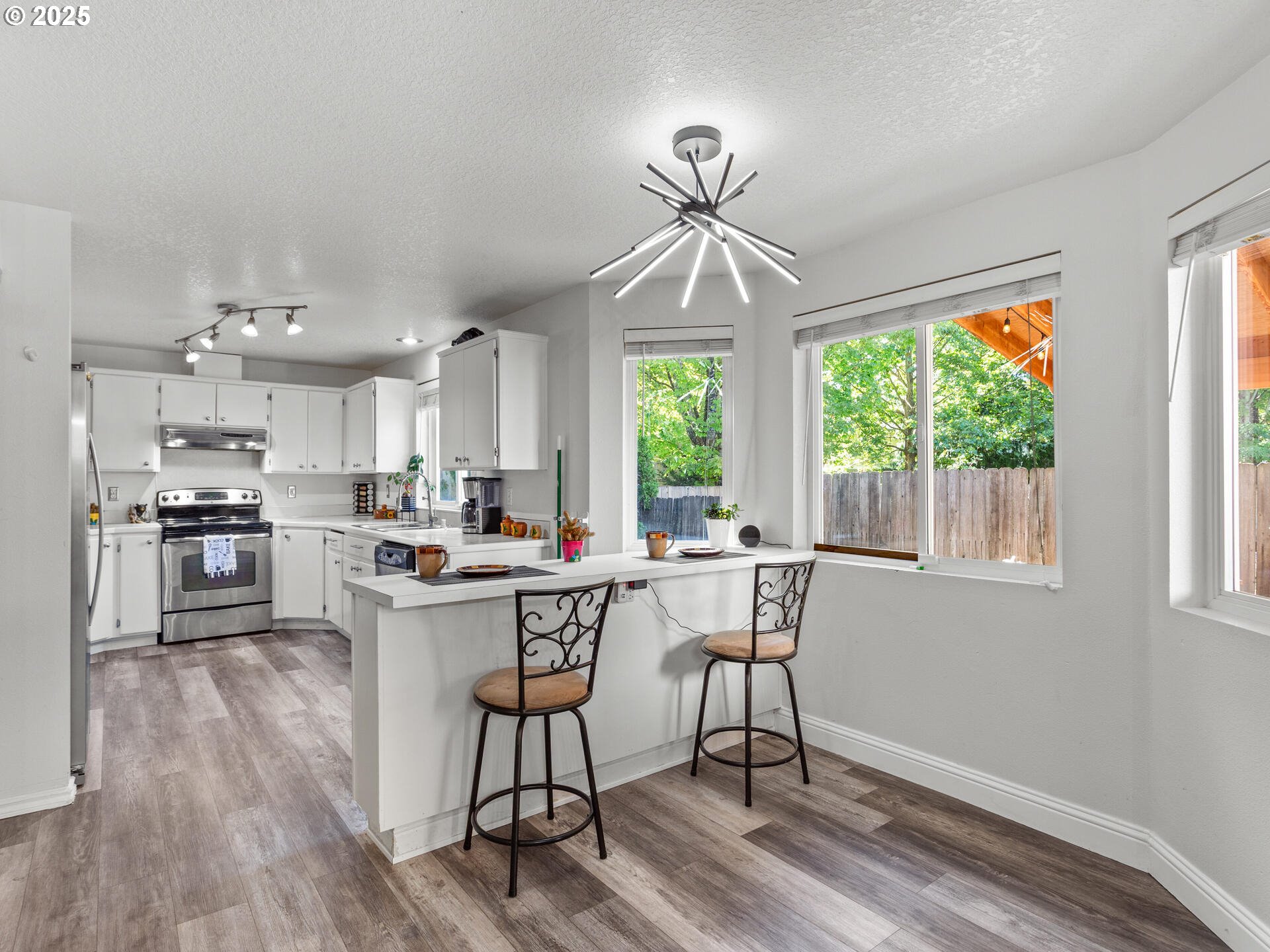 8292 Northeast Snowberry Loop Vancouver, WA 98664 - Photo 18 of 48 a view of a dining room with furniture window and wooden floor