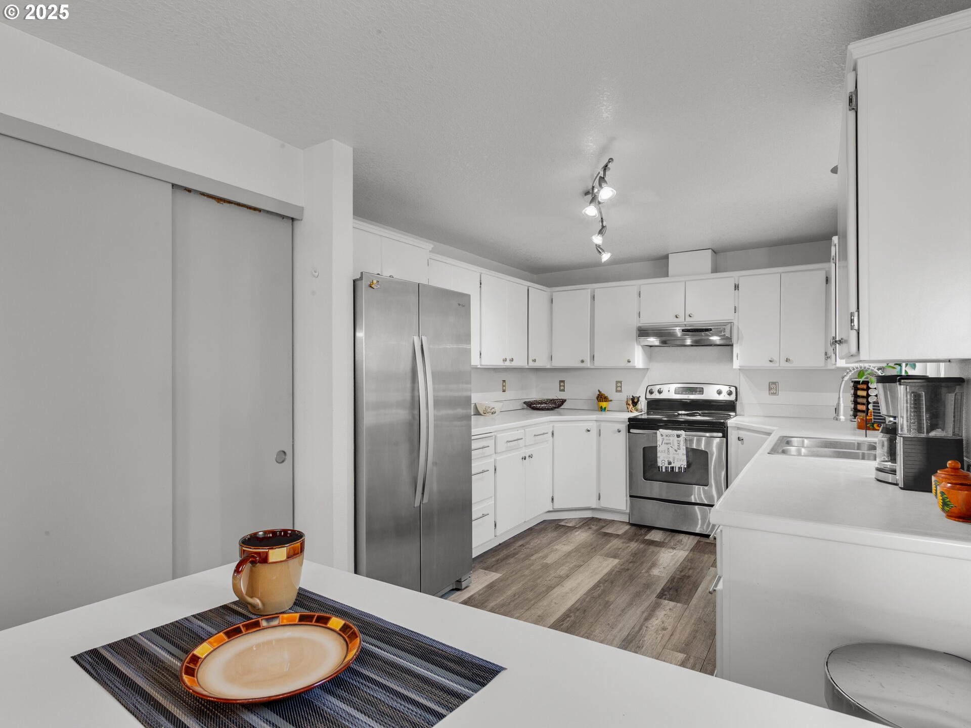 8292 Northeast Snowberry Loop Vancouver, WA 98664 - Photo 19 of 48 a kitchen with stainless steel appliances granite countertop a refrigerator sink and stove