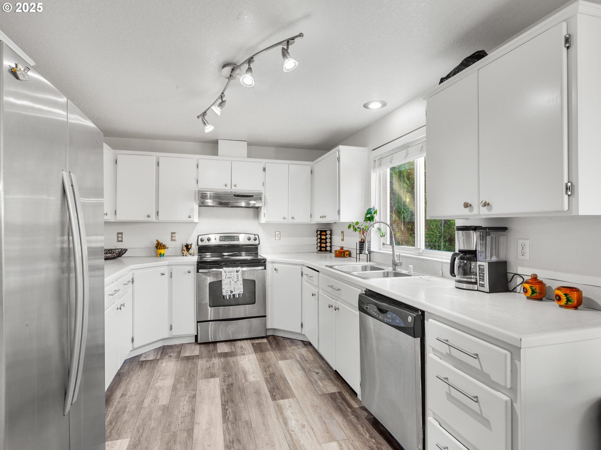 8292 Northeast Snowberry Loop Vancouver, WA 98664 - Photo 20 of 48 a kitchen with a white cabinets and white appliances