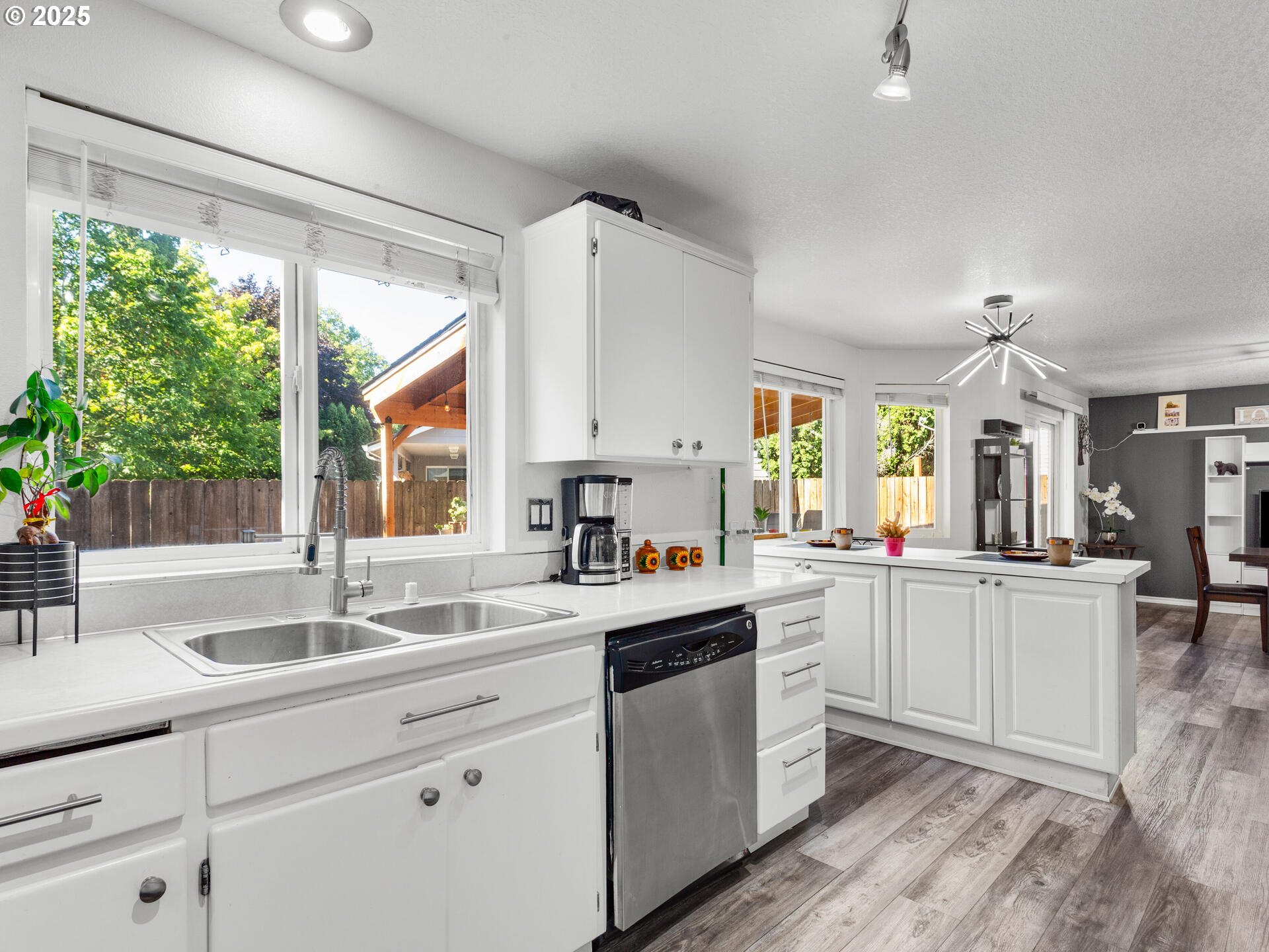 8292 Northeast Snowberry Loop Vancouver, WA 98664 - Photo 23 of 48 a kitchen with sink cabinets and wooden floor