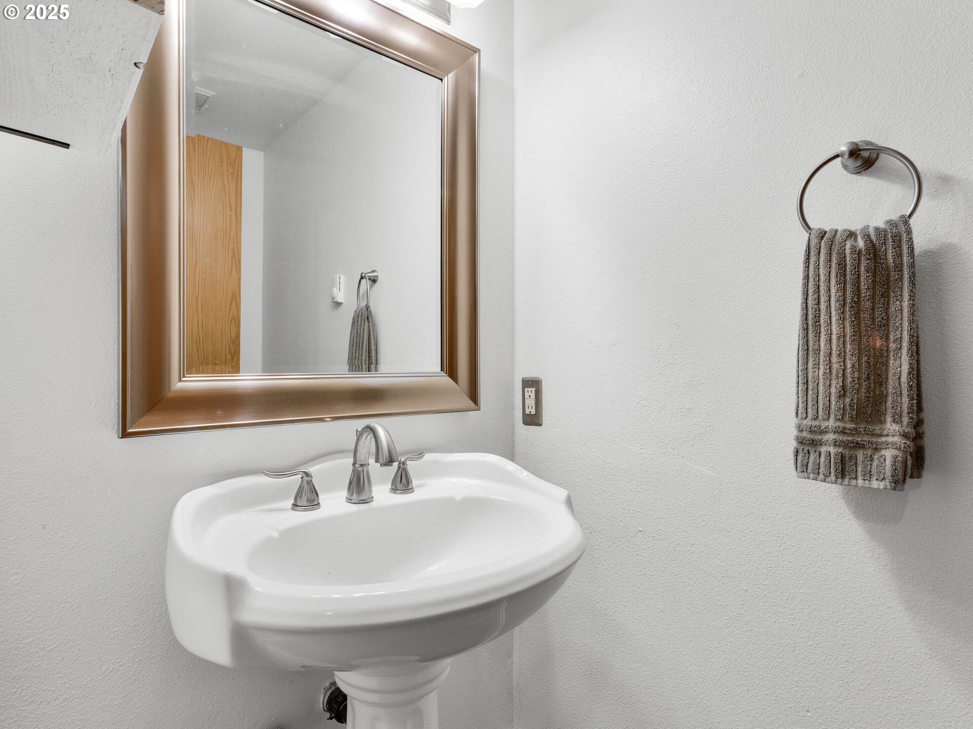 8292 Northeast Snowberry Loop Vancouver, WA 98664 - Photo 25 of 48 a bathroom with a sink and a mirror