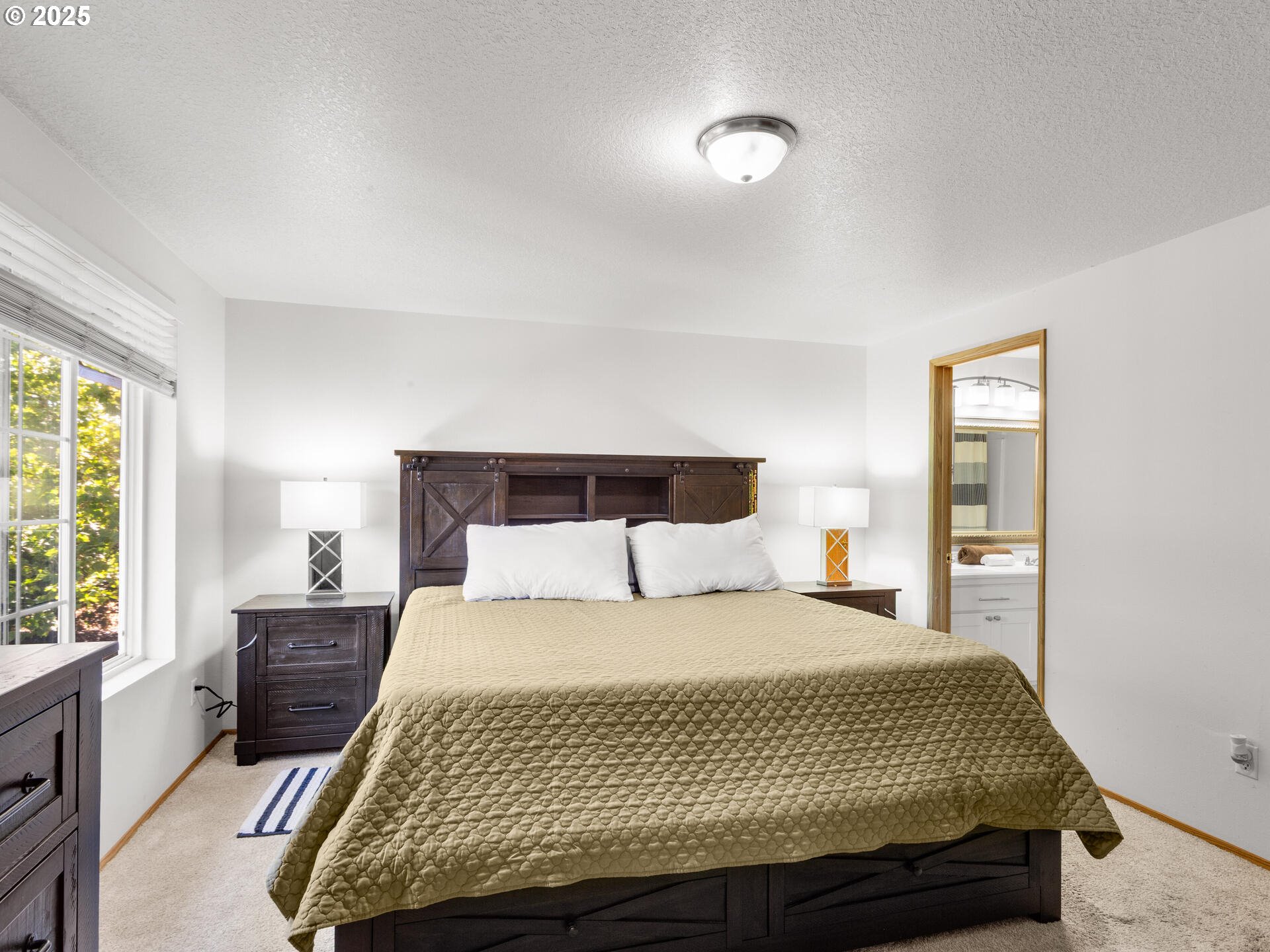 8292 Northeast Snowberry Loop Vancouver, WA 98664 - Photo 27 of 48 a bedroom with a bed and wooden floor