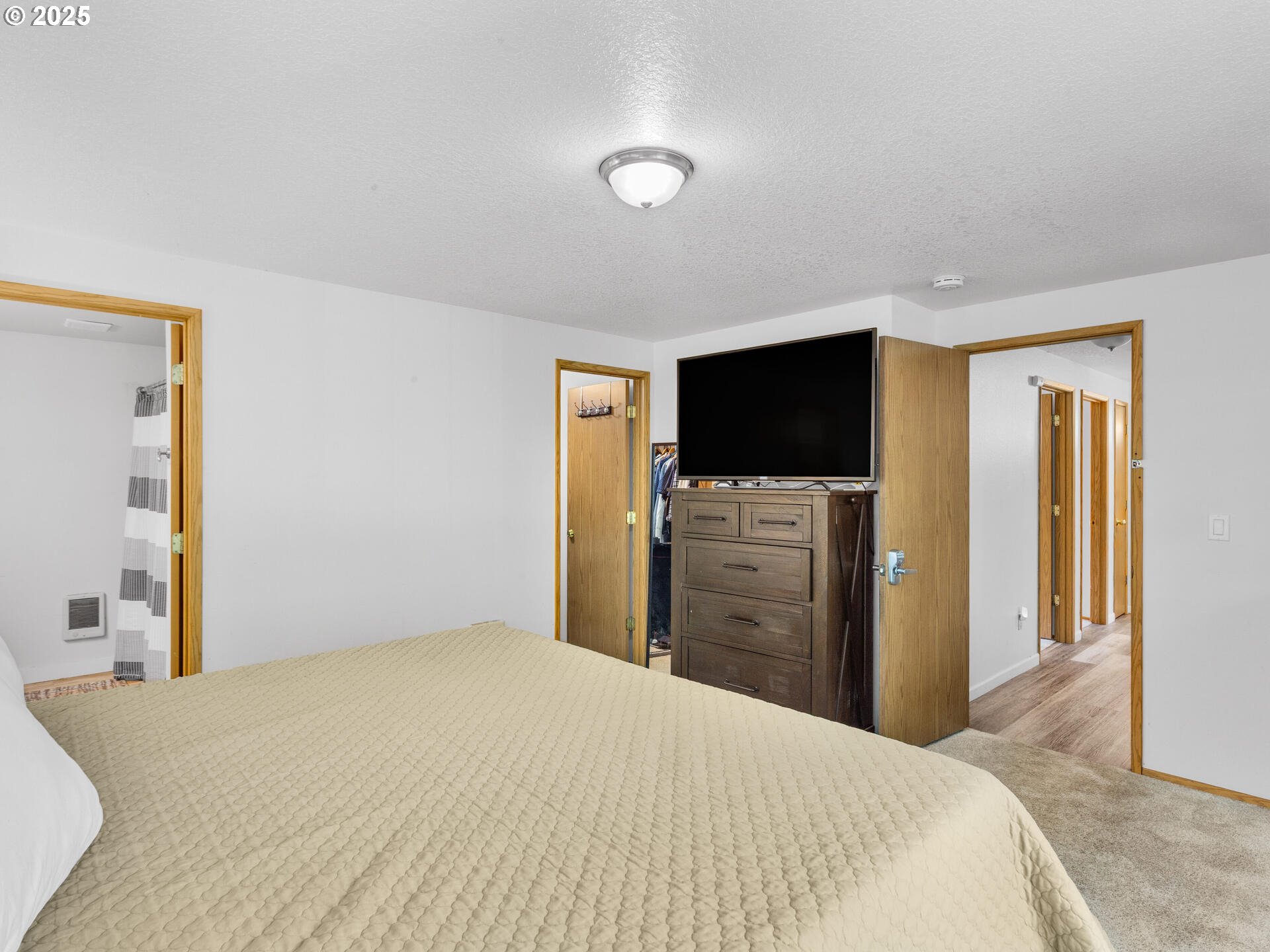 8292 Northeast Snowberry Loop Vancouver, WA 98664 - Photo 28 of 48 a bedroom with a bed and a flat screen tv