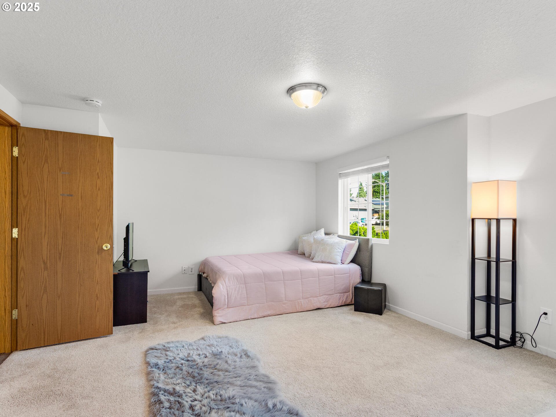 8292 Northeast Snowberry Loop Vancouver, WA 98664 - Photo 34 of 48 a bedroom with a bed and a lamp