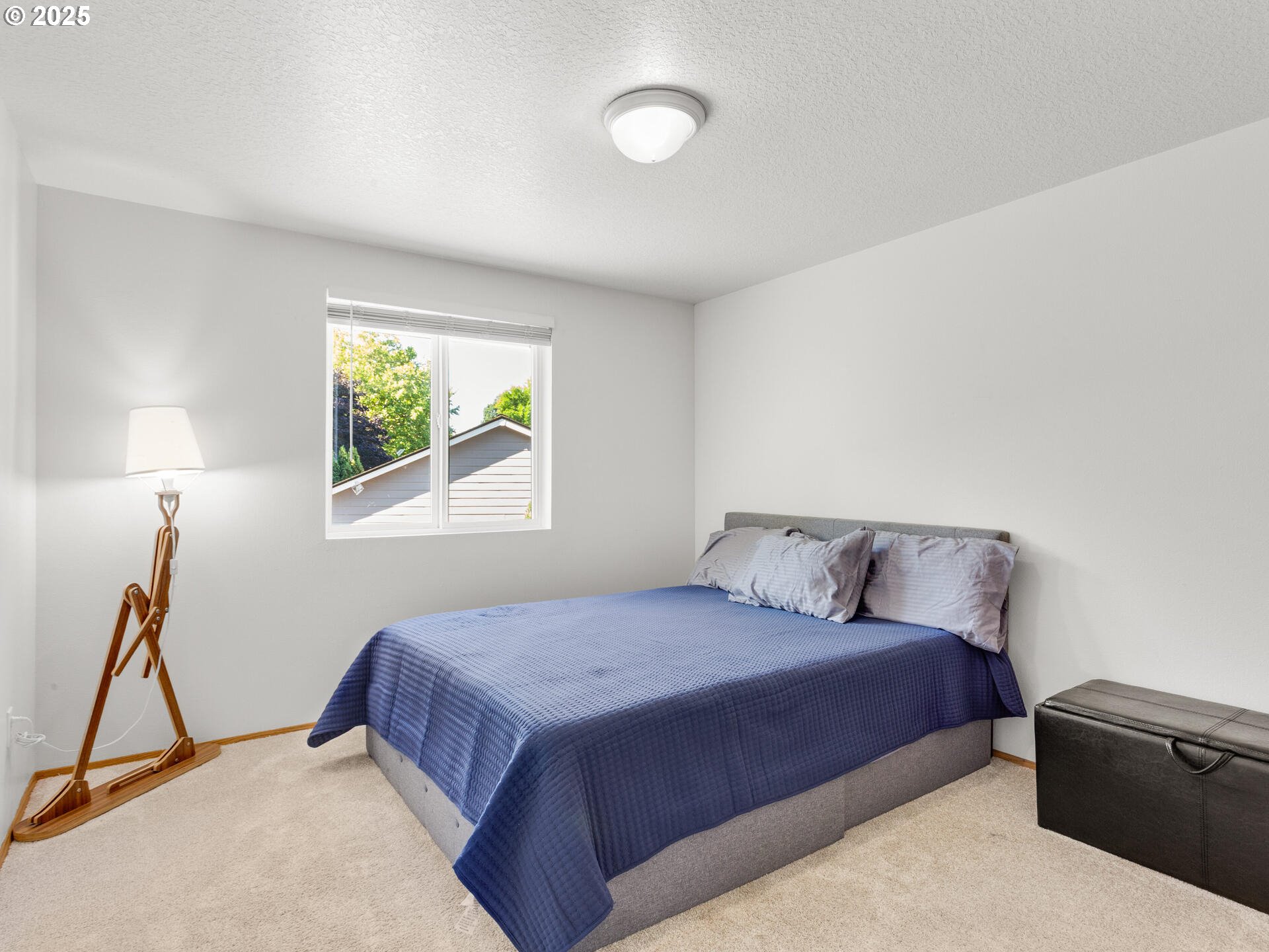 8292 Northeast Snowberry Loop Vancouver, WA 98664 - Photo 36 of 48 a bedroom with a bed and a window