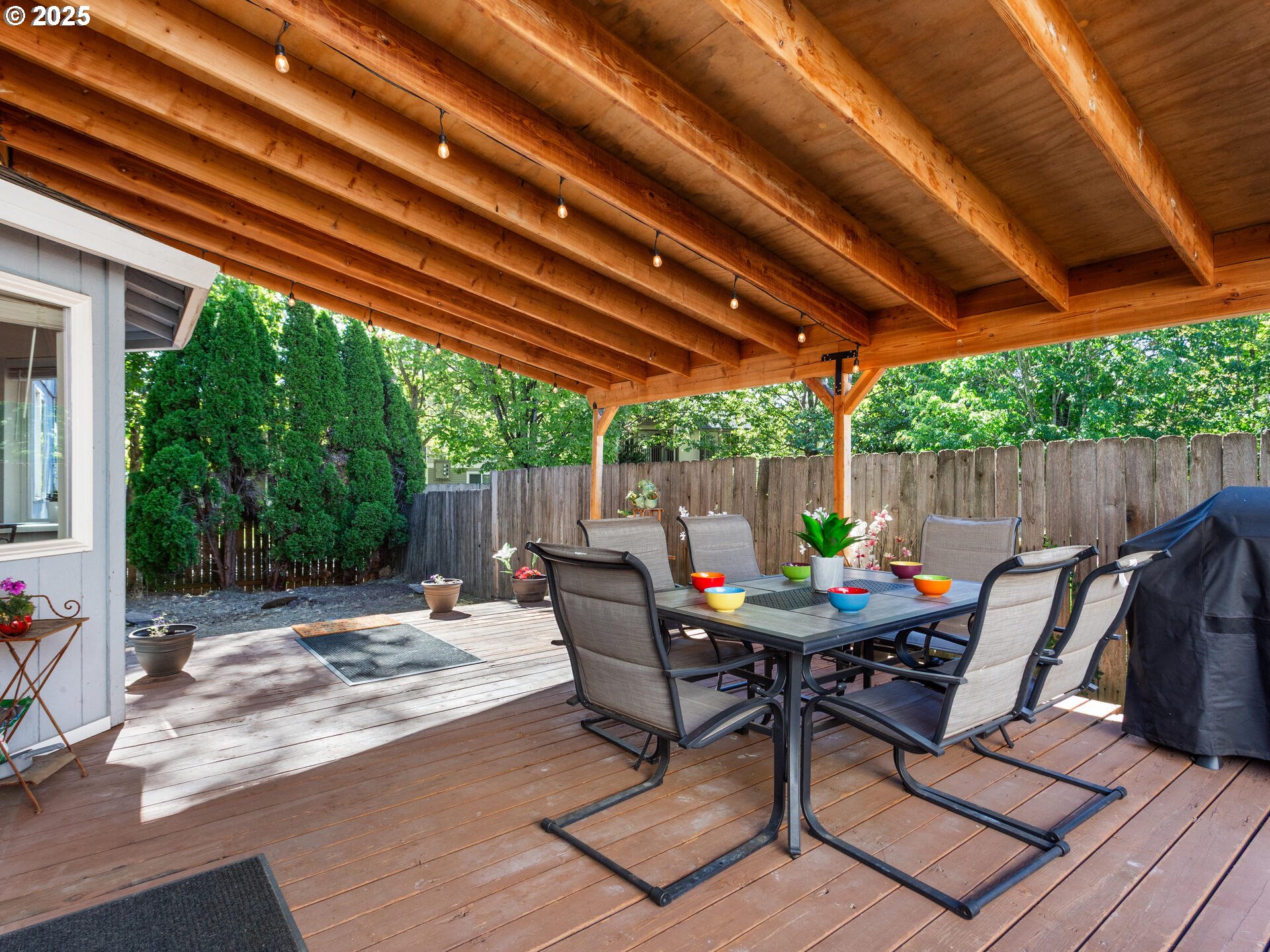 8292 Northeast Snowberry Loop Vancouver, WA 98664 - Photo 41 of 48 a view of patio with table and chairs under an umbrella with a barbeque