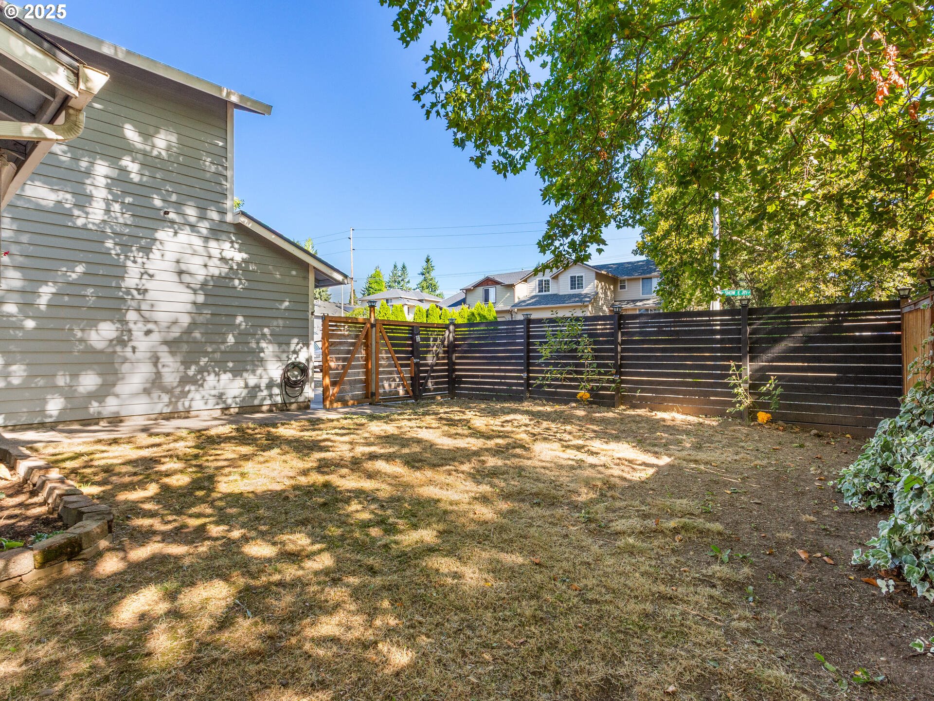 8292 Northeast Snowberry Loop Vancouver, WA 98664 - Photo 6 of 48 a view of a yard with wooden fence