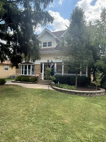 a view of a house with swimming pool next to a yard