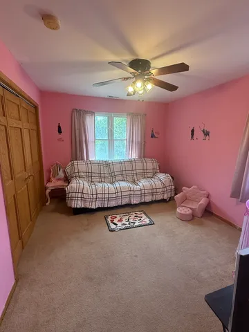 a bed room with a bed mirror and dresser