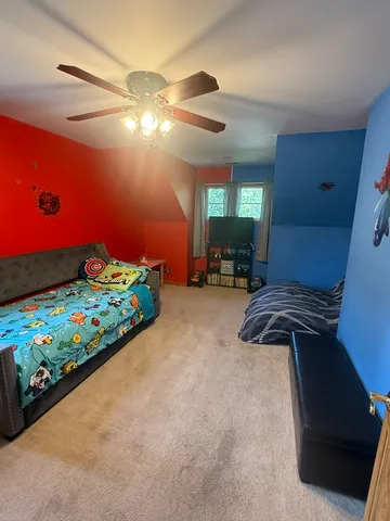 a bedroom with a bed and window