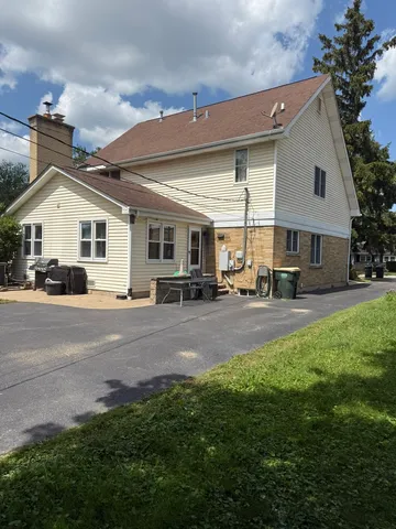 a swimming pool with outdoor seating and garden