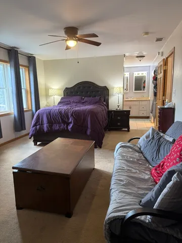 a bedroom with a bed and a chandelier