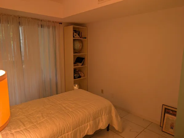 a bedroom with a bed and a shower curtain