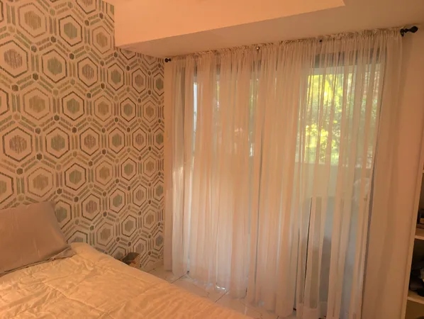 a bedroom with a lamp and a plant
