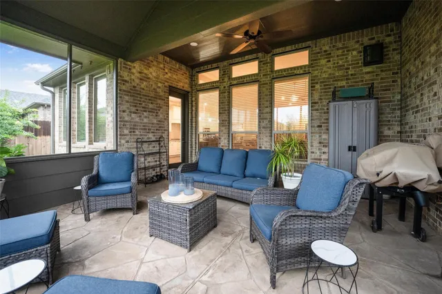 a outdoor living space with furniture and a large window