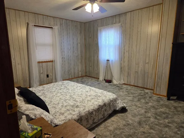 a bedroom with a bed and a chandelier