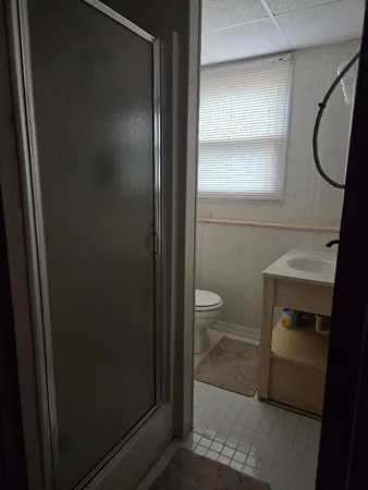 a bathroom with a toilet and a shower