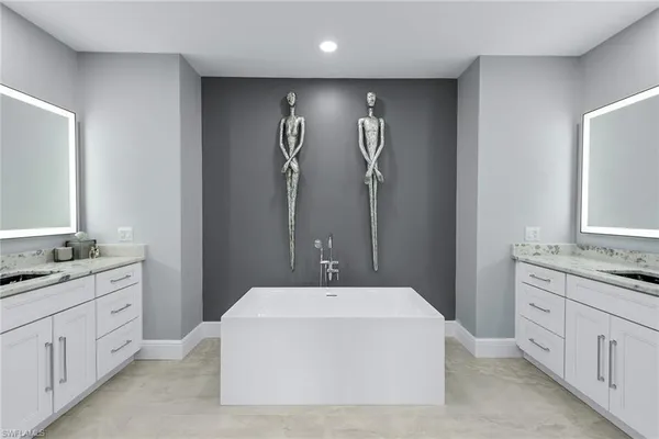 a en suite bathroom with a double vanity sink a mirror and a shower