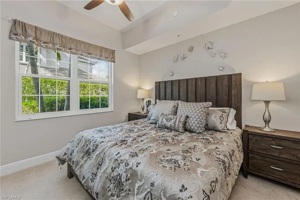 a bedroom with a large bed and a window