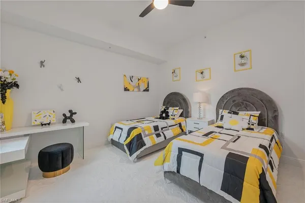 a bedroom with two beds and a dresser