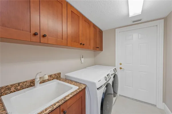 a utility room with a sink washer and dryer