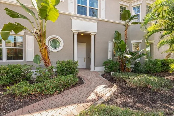 a view of a house with a small yard and plants