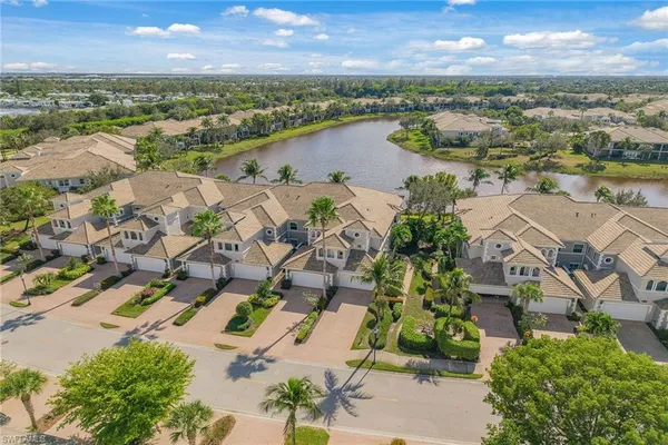 an aerial view of residential building with outdoor space and lake view