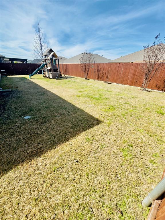 1508 Wild Rye Circle Princeton, TX 75407 - Photo 14 of 17 Fenced backyard with a playground