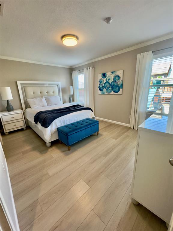 1508 Wild Rye Circle Princeton, TX 75407 - Photo 5 of 17 Bedroom featuring light wood-type flooring and ornamental molding