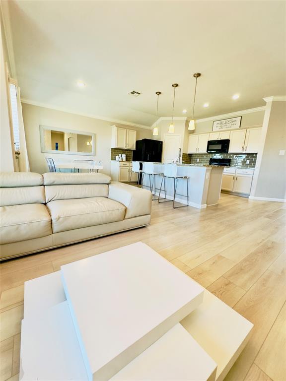 1508 Wild Rye Circle Princeton, TX 75407 - Photo 6 of 17 Living area featuring crown molding, light wood-type flooring, and recessed lighting